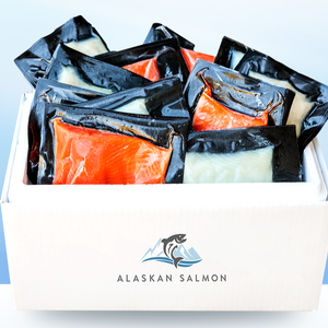 Vacuum-sealed salmon portions packed in a white box labeled ALASKAN SALMON