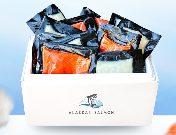 Vacuum-sealed portions of Alaskan Salmon and Halibut in a white box with Alaskan Salmon logo