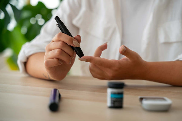 Person using a blood glucose meter to check blood sugar level