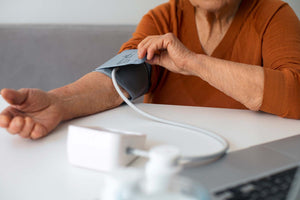 an elderly woman taking her blood pressure after eating salmon