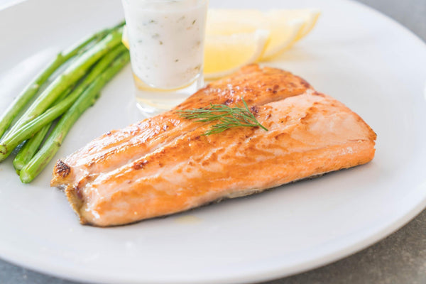 bake salmon at 400 served with asparagus on white plate