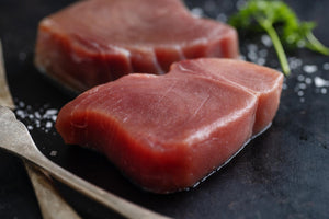 raw tuna slices on dark background