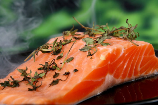 salmon fillet with herbs on top