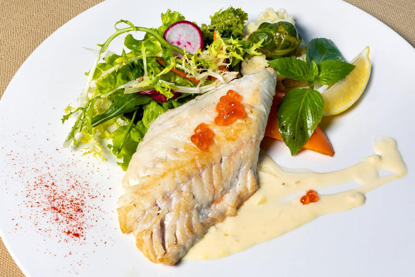 steamed halibut on a white plate