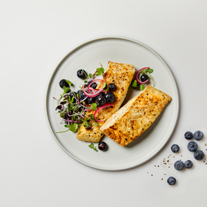cooked alaskan halibut in white plate